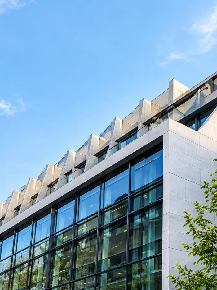 Modern glass and stone architecture in the illustrative website